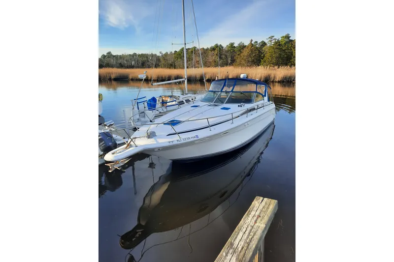 Slide: The Image of 1990 Sea Ray Sundancer 370 docked on calm water with clear blue sky. - 6