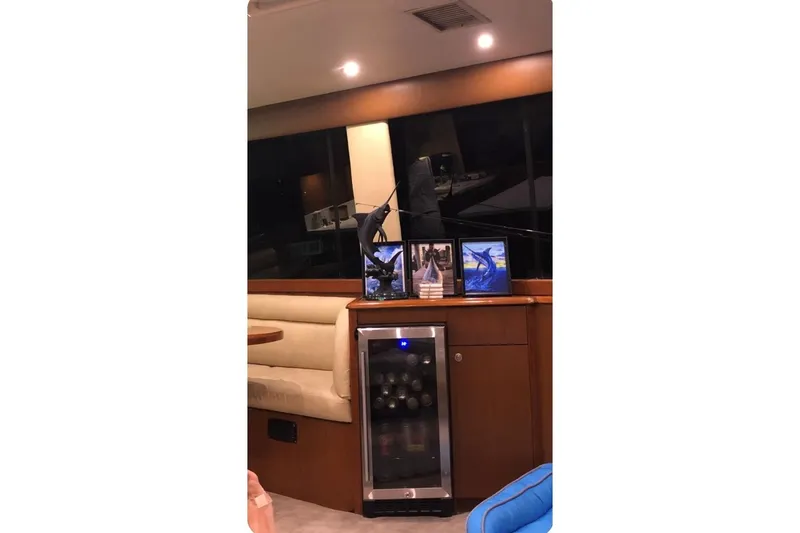 Slide: The Image of Interior of 1998 Ocean 53 Convertible yacht with wine cooler and framed photos. - 10