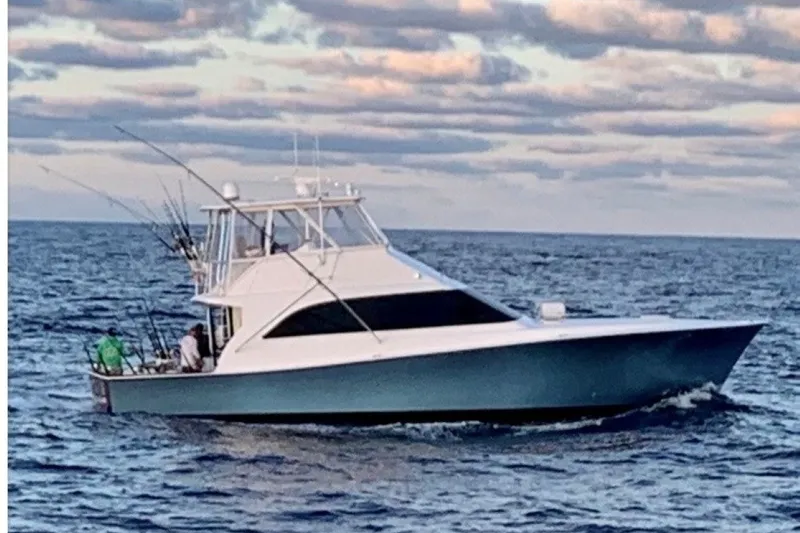 Slide: The Image of 1998 Ocean Yachts 53 Super Sport cruising on open sea under cloudy sky. - 4