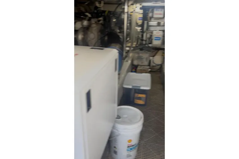Slide: The Image of Engine room of a 1998 Ocean 53 Convertible yacht with storage containers and equipment. - 13