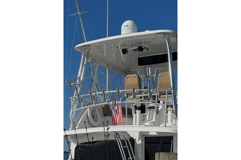 Slide: The Image of 1998 Ocean 53 Convertible yacht with fishing rods and American flag. - 15