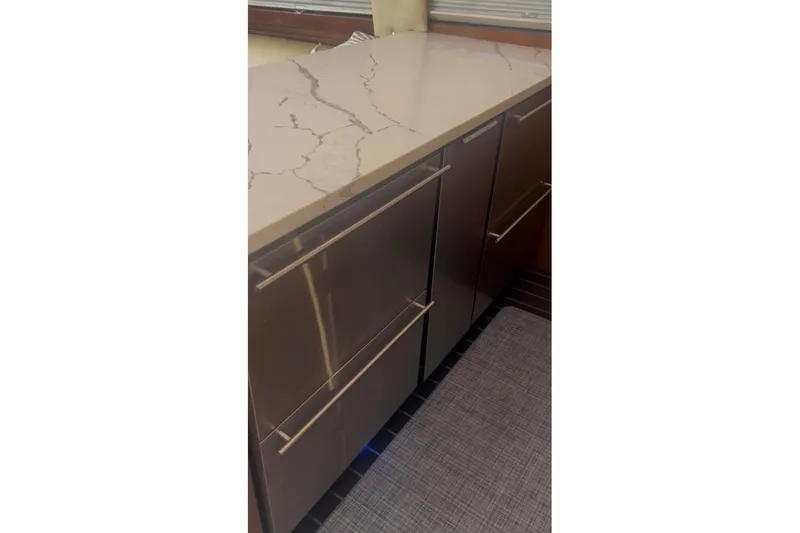 Slide: The Image of Modern kitchen cabinetry with sleek handles and marble countertop on Ocean 53 Convertible yacht. - 16