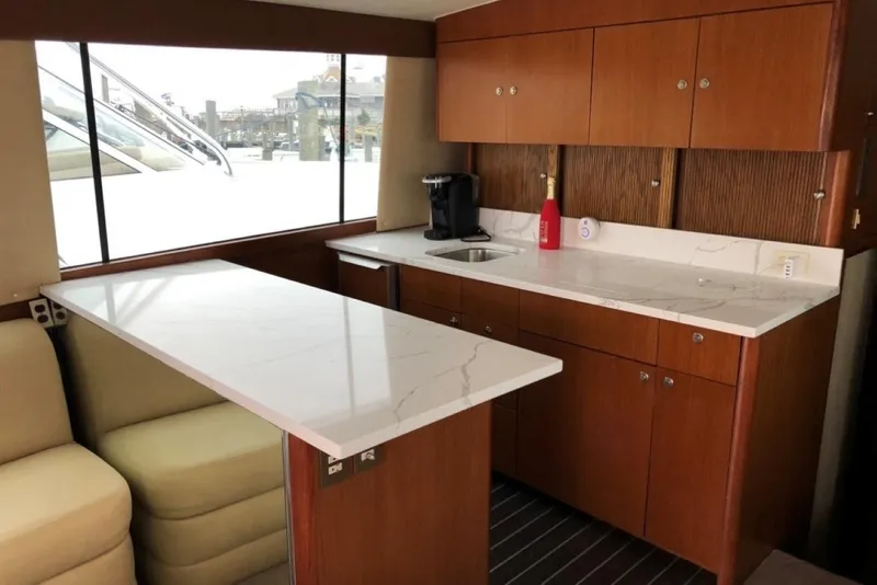 Slide: The Image of Luxurious interior of a 1998 Ocean 53 Convertible yacht with modern kitchen amenities. - 18