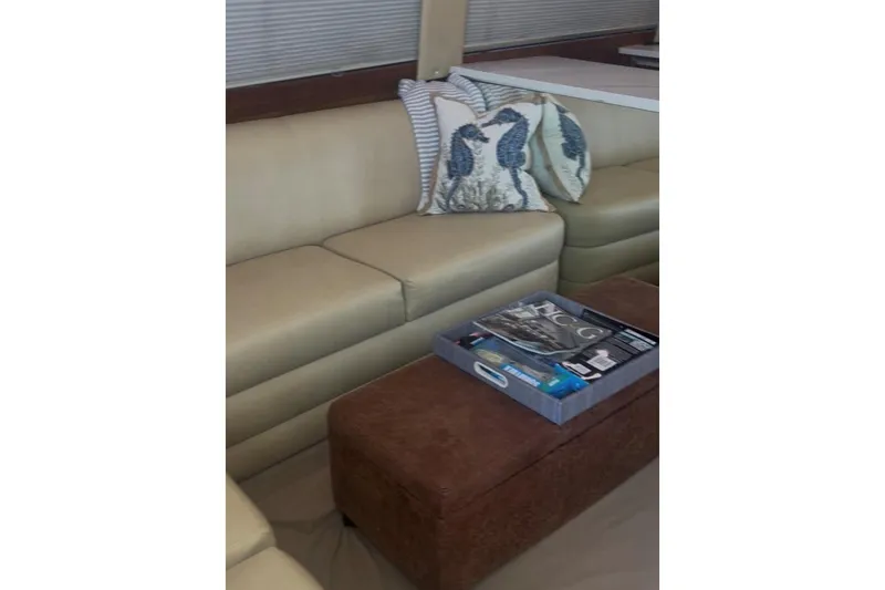 Slide: The Image of Luxurious interior of 1998 Ocean 53 Convertible yacht with beige seating and decorative pillows. - 25
