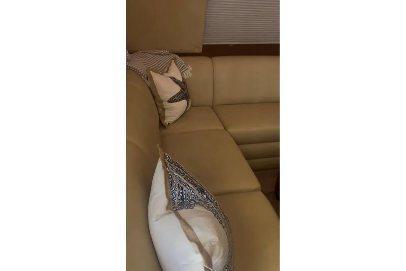 Slide: The Image of Luxurious beige seating with decorative pillows on a 1998 Ocean 53 Convertible yacht. - 26