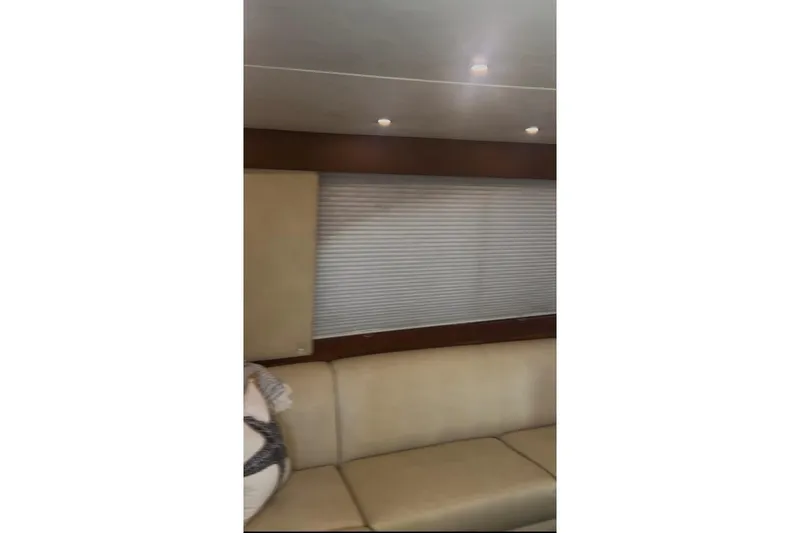 Slide: The Image of Interior of 1998 Ocean 53 Convertible yacht with beige seating and window blinds. - 27