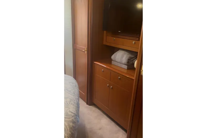 Slide: The Image of Interior of 1998 Ocean 53 Convertible yacht with wooden cabinetry and bedding. - 30