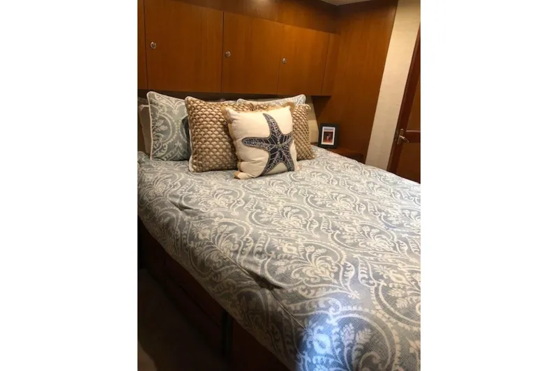 Slide: The Image of Cozy bedroom in 1998 Ocean 53 Convertible yacht with starfish-themed bedding. - 31
