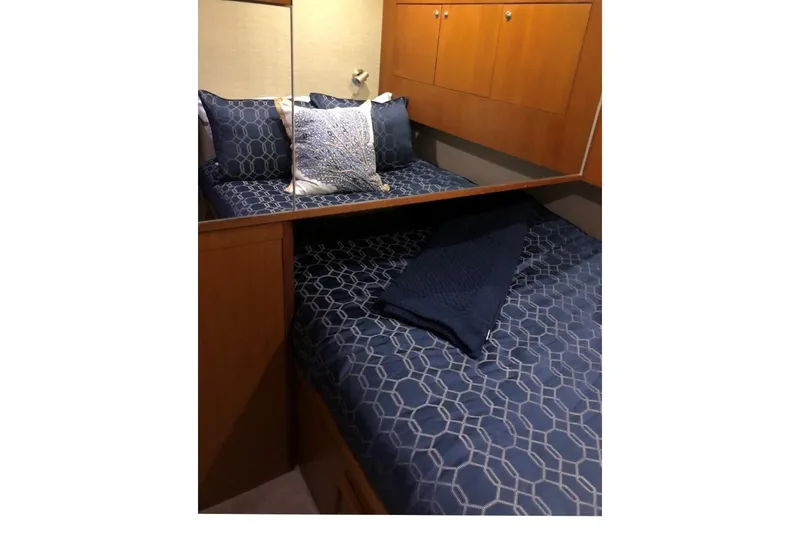 Slide: The Image of Cozy bedroom in 1998 Ocean 53 Convertible yacht with blue geometric bedding. - 32