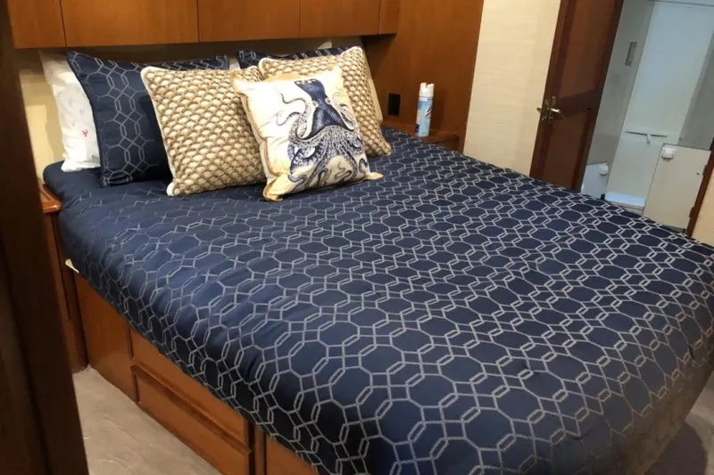 Slide: The Image of Luxurious bedroom interior of 1998 Ocean 53 Convertible yacht with nautical-themed bedding. - 33