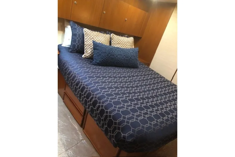 Slide: The Image of Luxurious bedroom interior of 1998 Ocean 53 Convertible yacht with geometric bedding. - 34