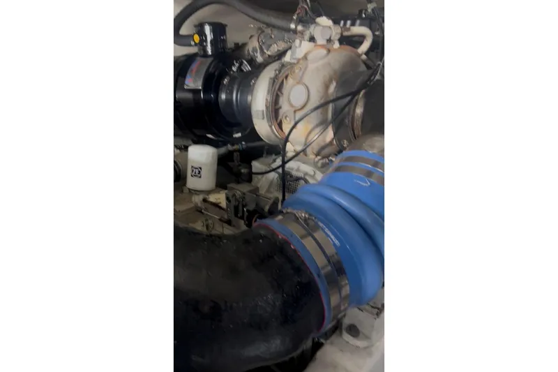 Slide: The Image of Engine compartment of a 1998 Ocean 53 Convertible yacht, featuring hoses and components. - 36