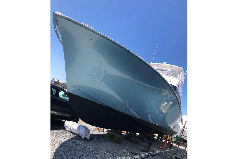 Slide: The Image of 1998 Ocean 53 Convertible yacht on dry dock under clear blue sky. - 39