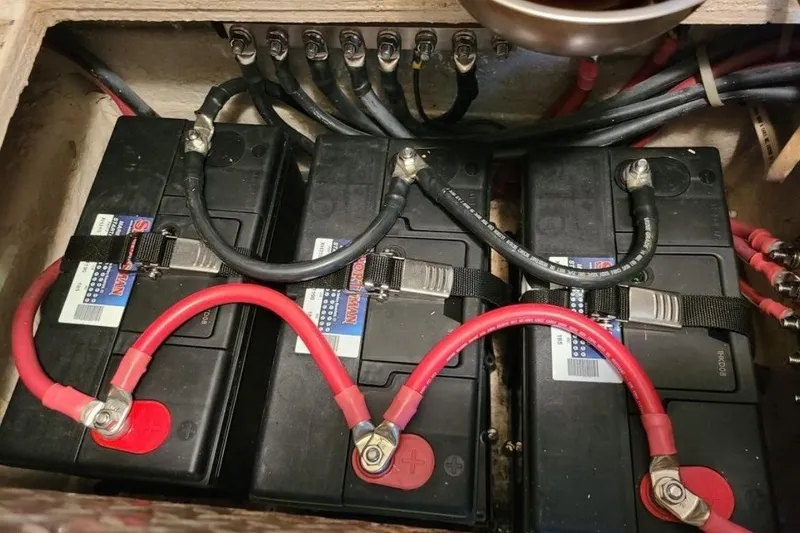 Slide: The Image of Battery compartment of a 1998 Ocean 53 Convertible boat with connected cables. - 41