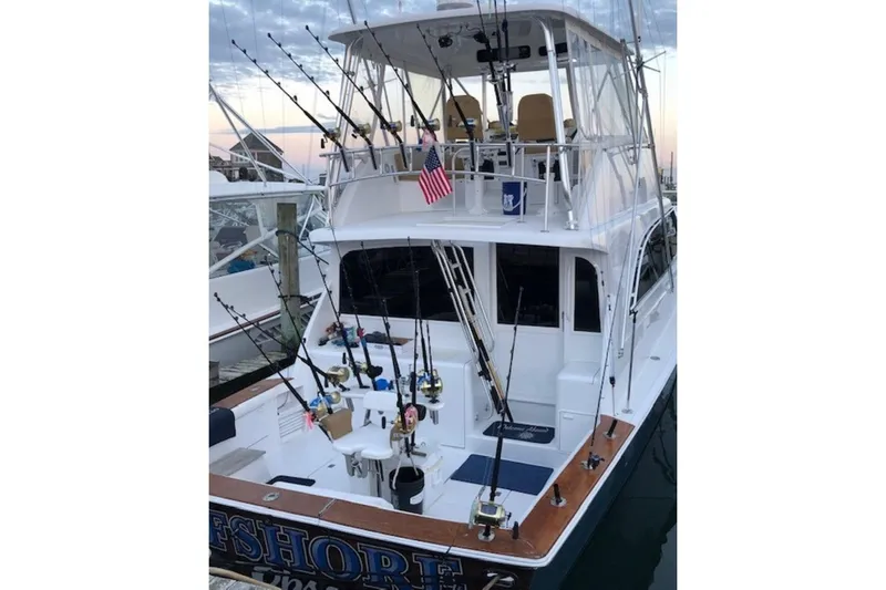 Slide: The Image of 1998 Ocean 53 Convertible yacht with fishing rods docked at marina. - 5