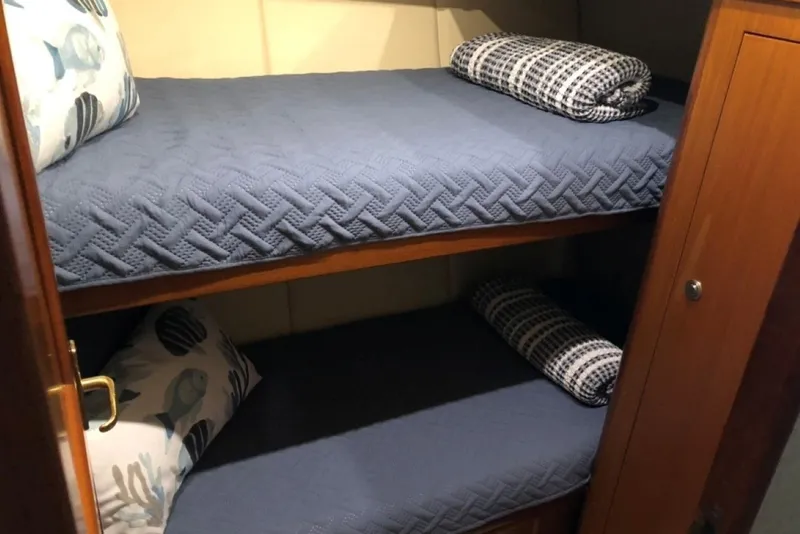 Slide: The Image of Bunk beds with blue bedding in a 1998 Ocean 53 Convertible yacht cabin. - 8