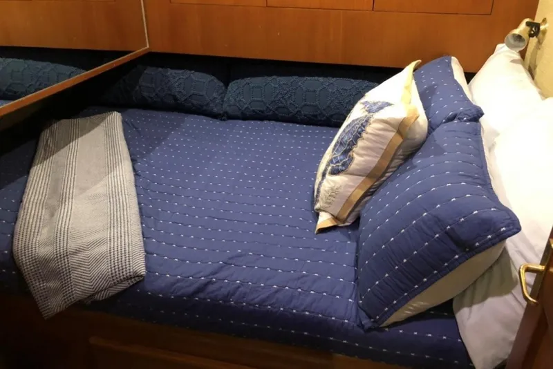 Slide: The Image of Cozy cabin bed with blue bedding in 1998 Ocean 53 Convertible yacht. - 9