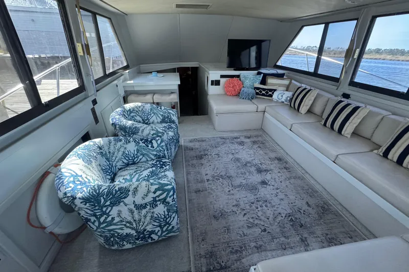 Slide: The Image of Luxurious interior of a 1990 Hatteras 52 Convertible yacht with plush seating and nautical decor. - 10