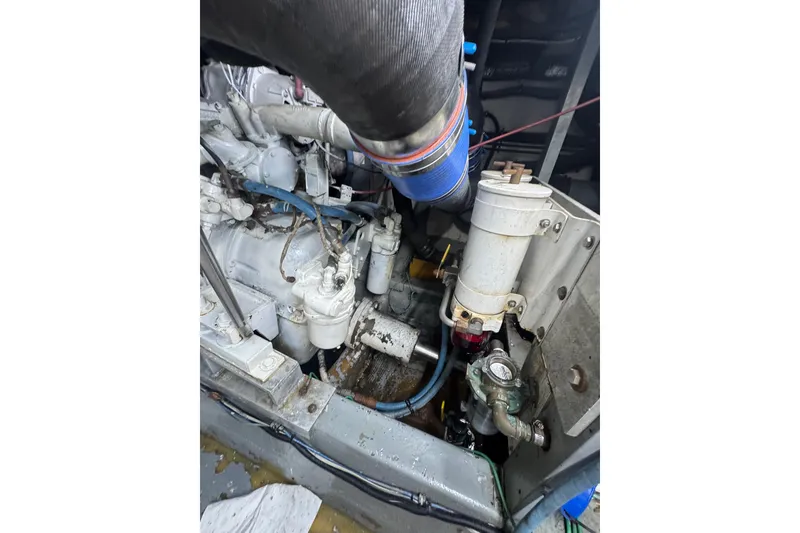 Slide: The Image of Engine compartment of a 1990 Hatteras 52 Convertible boat, showcasing mechanical components. - 21