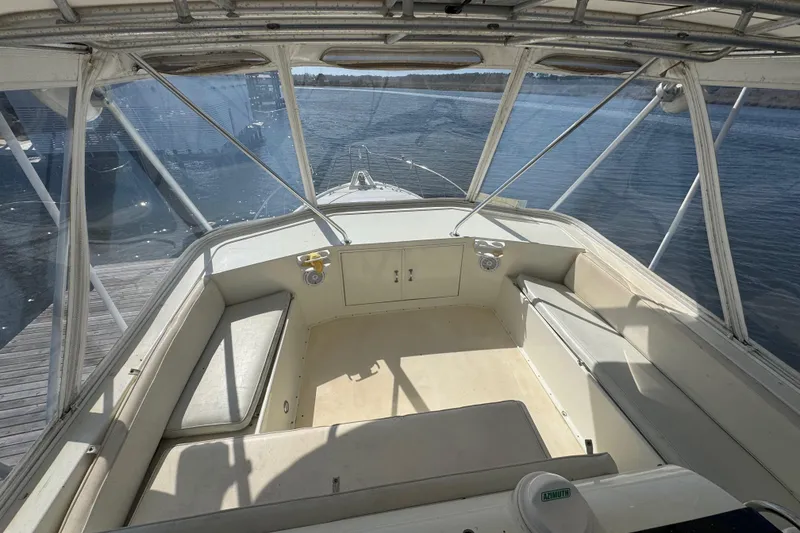 Slide: The Image of 1990 Hatteras 52 Convertible boat interior with seating and water view. - 4