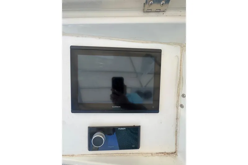 Slide: The Image of Garmin and Fusion marine electronics on 1990 Hatteras 52 Convertible yacht dashboard. - 6