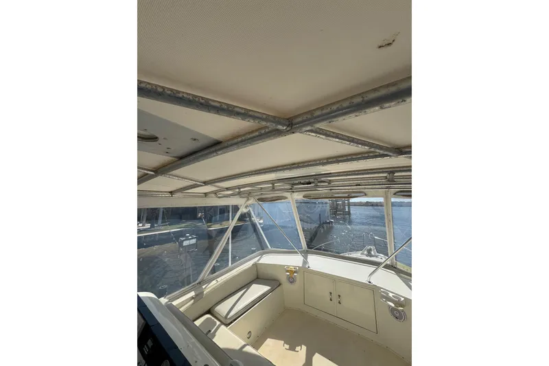 Slide: The Image of Interior view of 1990 Hatteras 52 Convertible boat with metal framework and windows. - 8