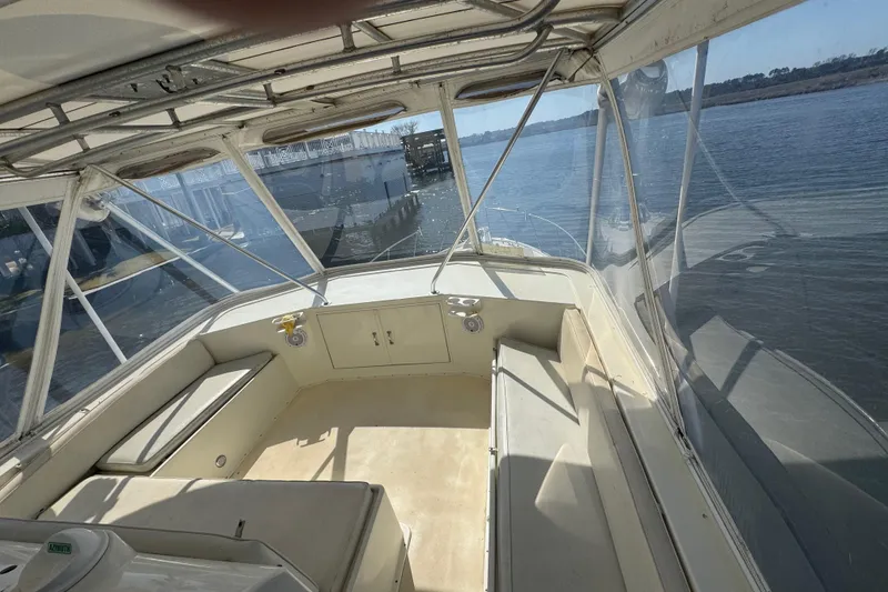 Slide: The Image of Interior view of 1990 Hatteras 52 Convertible yacht with clear windows and seating. - 9
