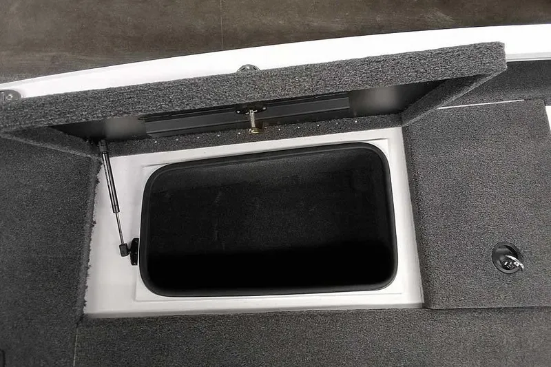 Slide: The Image of Open storage compartment in 2022 Vexus AVX1980 boat, featuring carpeted interior. - 13