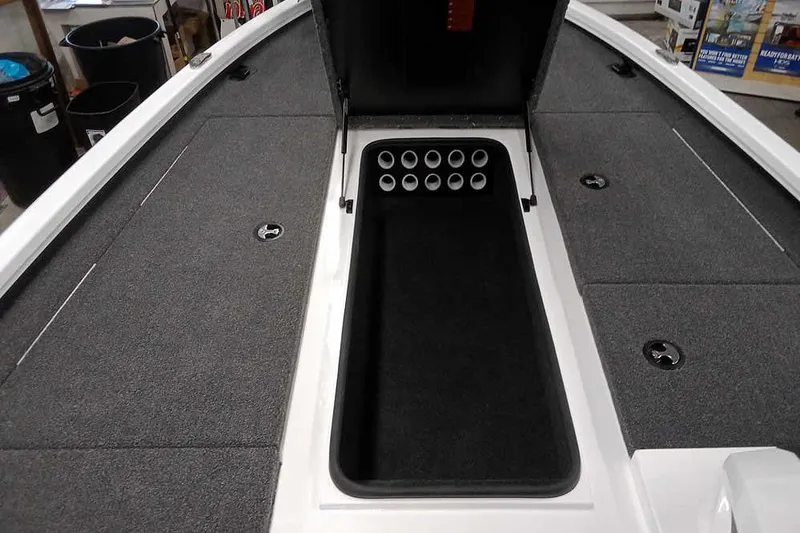 Slide: The Image of 2022 Vexus AVX1980 boat interior with open storage compartment and rod holders. - 14