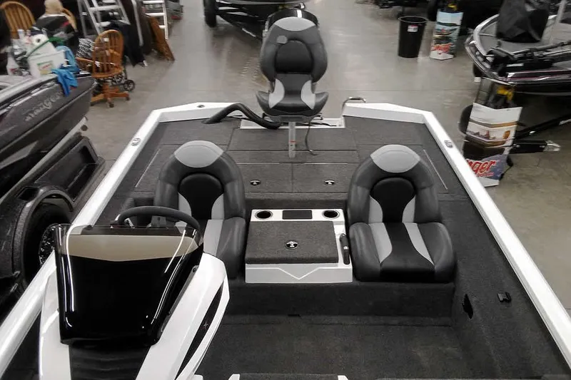 Slide: The Image of 2022 Vexus AVX1980 boat interior with seating and console, displayed indoors. - 16