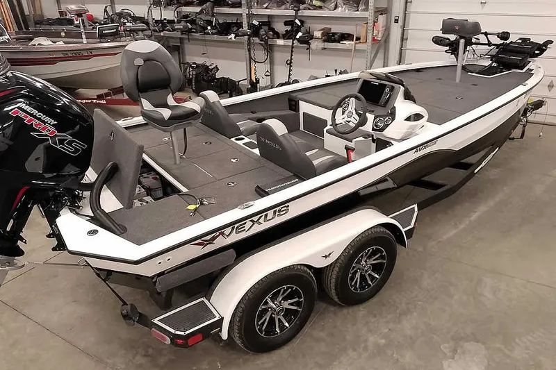 Slide: The Image of 2022 Vexus AVX1980 boat with Mercury Pro XS engine in a garage setting. - 2