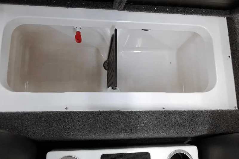 Slide: The Image of Livewell compartment in 2022 Vexus AVX1980 boat, featuring a divider and drainage system. - 23