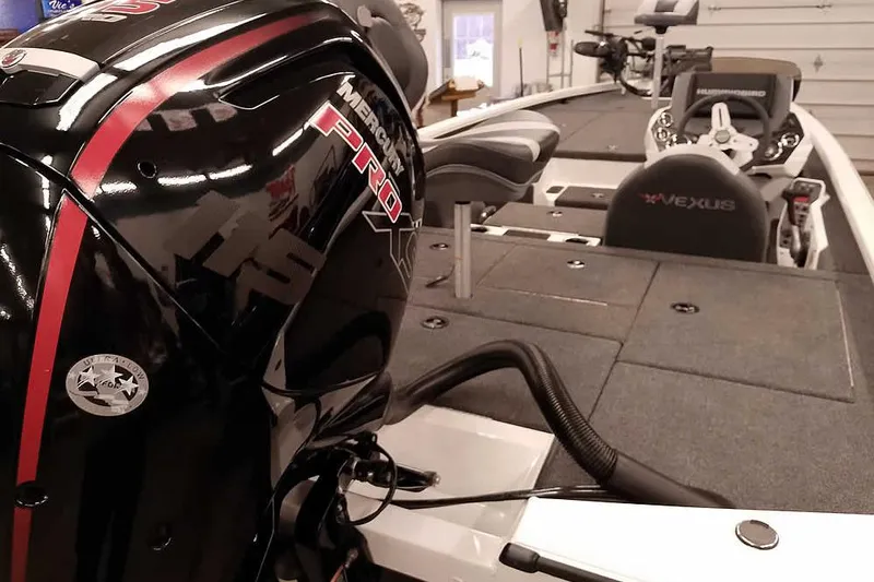 Slide: The Image of 2022 Vexus AVX1980 boat with Mercury Pro XS engine in a garage setting. - 3