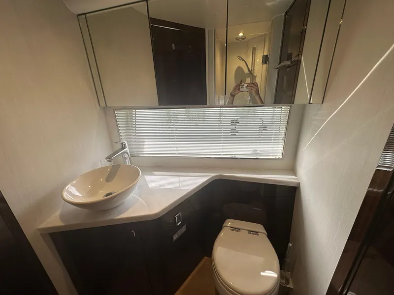 Slide: The Image of Modern bathroom in 2024 Fairline Targa 45 GT yacht with sink, toilet, and mirrored cabinets. - 10