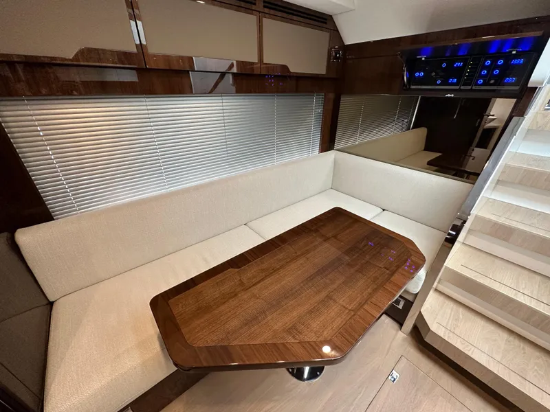 Slide: The Image of 2024 Fairline Targa 45 GT interior with elegant seating and wooden table. - 12