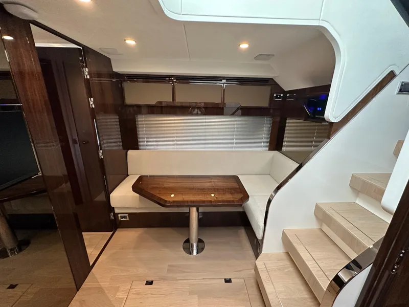 Slide: The Image of 2024 Fairline Targa 45 GT interior with modern seating and wooden table. - 13