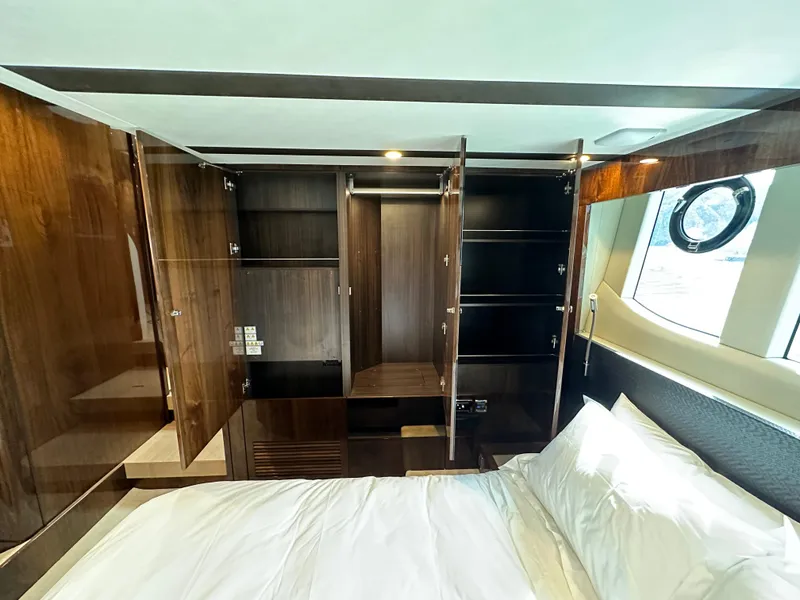 Slide: The Image of 2024 Fairline Targa 45 GT bedroom with open wooden cabinets and bed - 21
