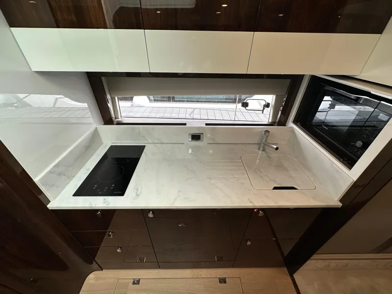 Slide: The Image of Modern kitchen area in 2024 Fairline Targa 45 GT yacht with marble countertop. - 24