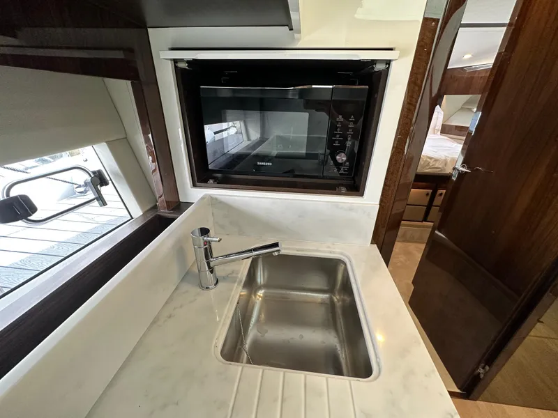 Slide: The Image of 2024 Fairline Targa 45 GT yacht kitchen with sink and microwave - 25