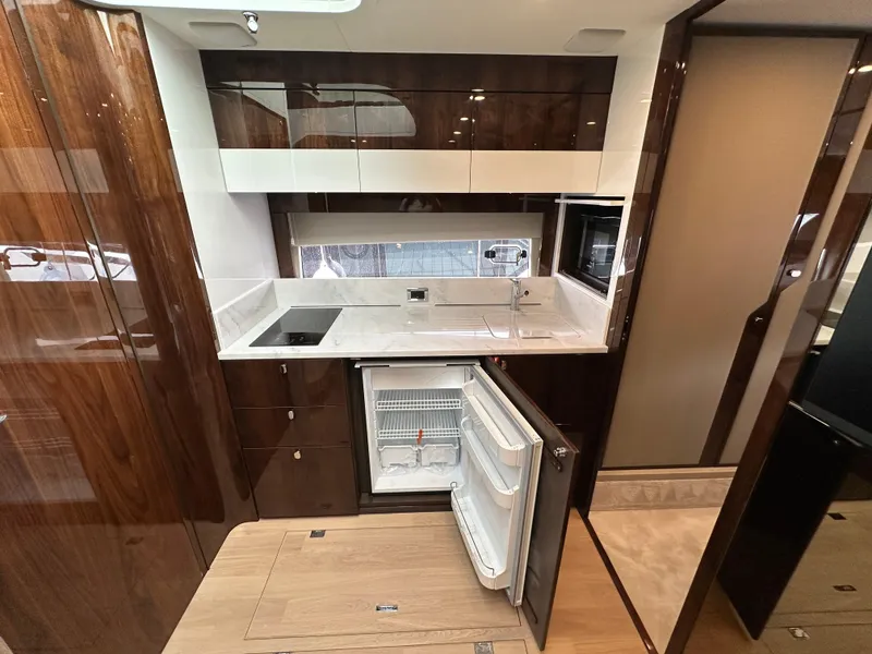 Slide: The Image of 2024 Fairline Targa 45 GT yacht kitchen with modern appliances and sleek cabinetry. - 26