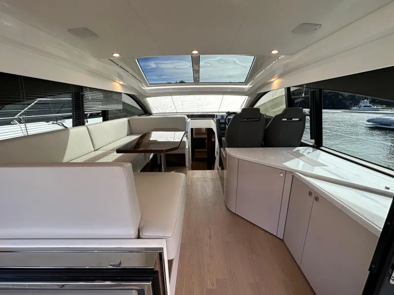 Slide: The Image of Interior of 2024 Fairline Targa 45 GT yacht with modern seating and panoramic windows. - 28