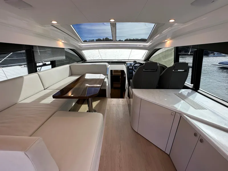 Slide: The Image of Interior of 2024 Fairline Targa 45 GT yacht with modern seating and panoramic windows. - 29