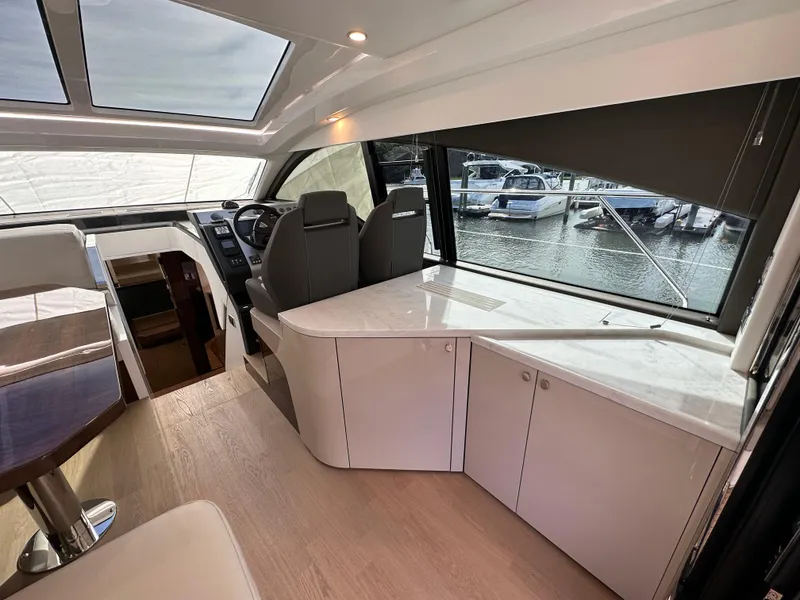 Slide: The Image of Interior of 2024 Fairline Targa 45 GT yacht with modern design and marina view. - 30