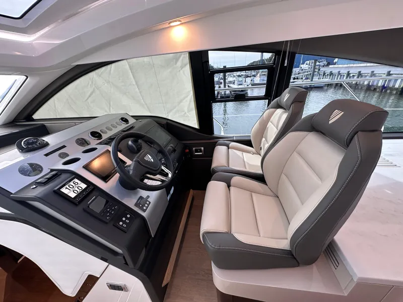 Slide: The Image of Interior helm of 2024 Fairline Targa 45 GT yacht with dual seats and modern controls. - 34