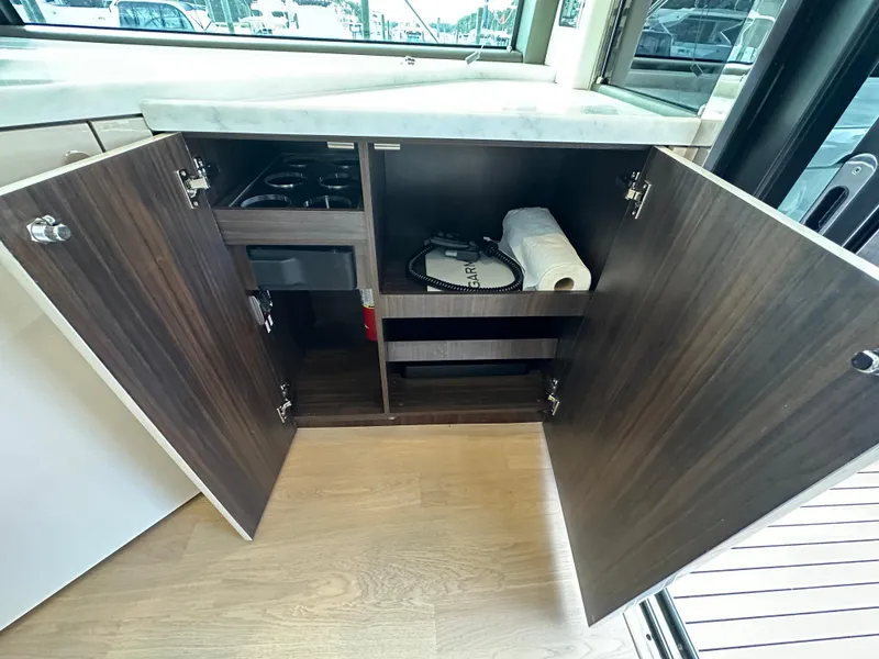 Slide: The Image of Open cabinet storage in the 2024 Fairline Targa 45 GT yacht kitchen. - 38