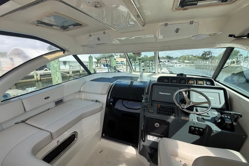 Slide: The Image of Interior of a 2009 Pursuit OS 375 Offshore boat, featuring helm and seating area. - 14