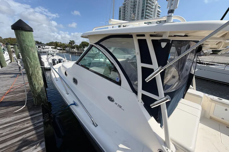 Slide: The Image of 2009 Pursuit OS 375 Offshore boat docked at marina under clear skies. - 6