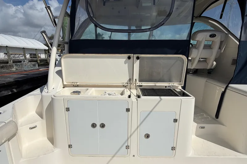 Slide: The Image of 2009 Pursuit OS 375 Offshore boat deck with storage compartments and seating. - 9