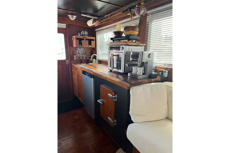 Slide: The Image of 1979 Cheoy Lee Sedan 35 interior kitchen with appliances and wooden cabinetry. - 10
