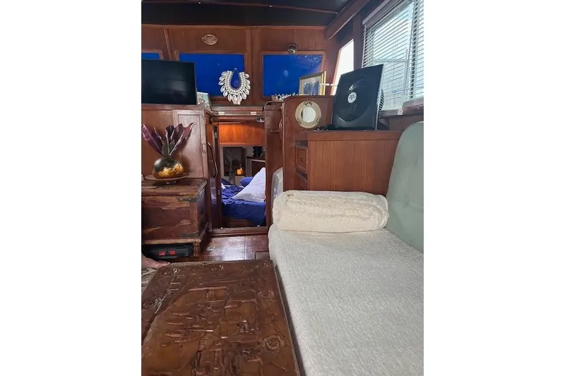 Slide: The Image of Interior of a 1979 Cheoy Lee Sedan 35 yacht with wooden furnishings and decor. - 5